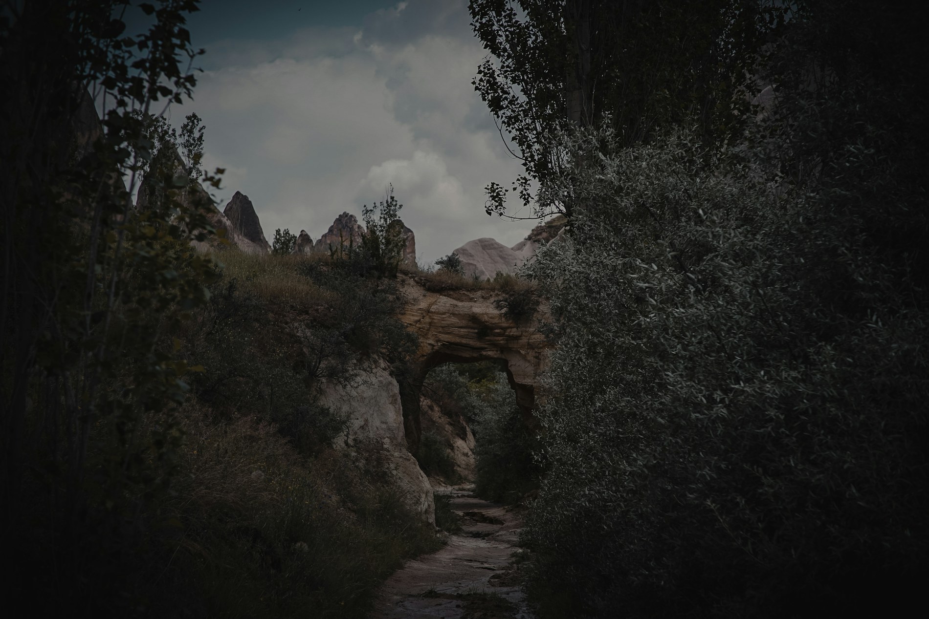 A dramatic mountain landscape beneath a vast sky