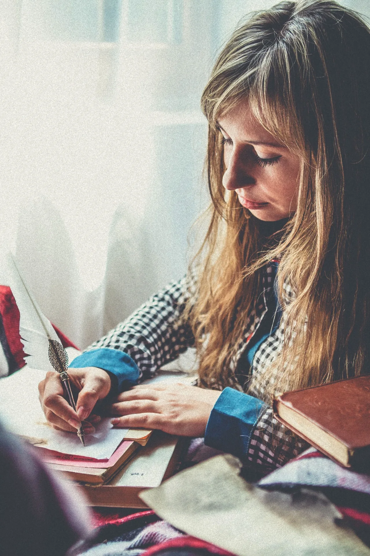 A woman writing in a notebook during a quiet moment at home