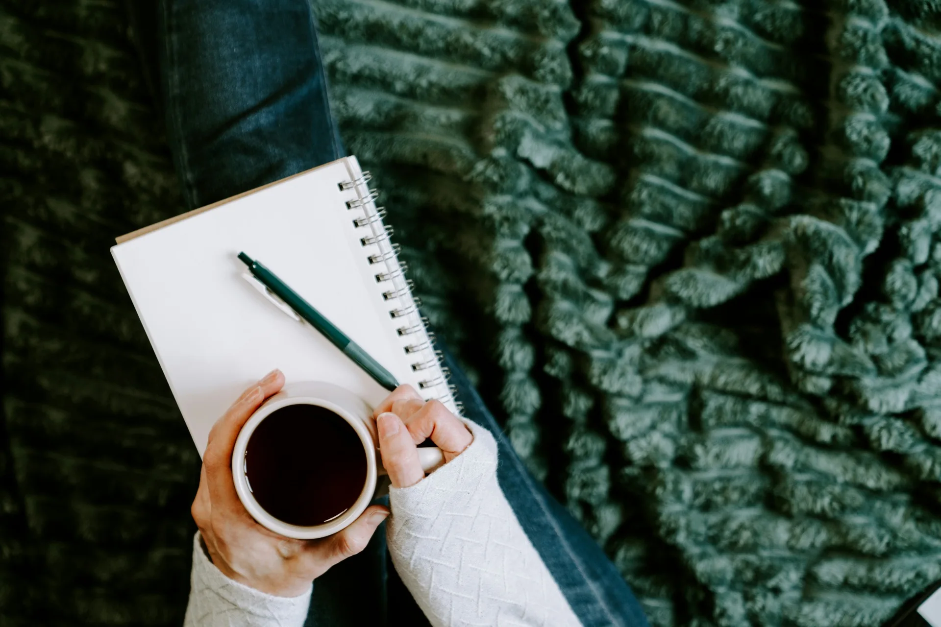 A notebook and cup of coffee while someone considers their next steps